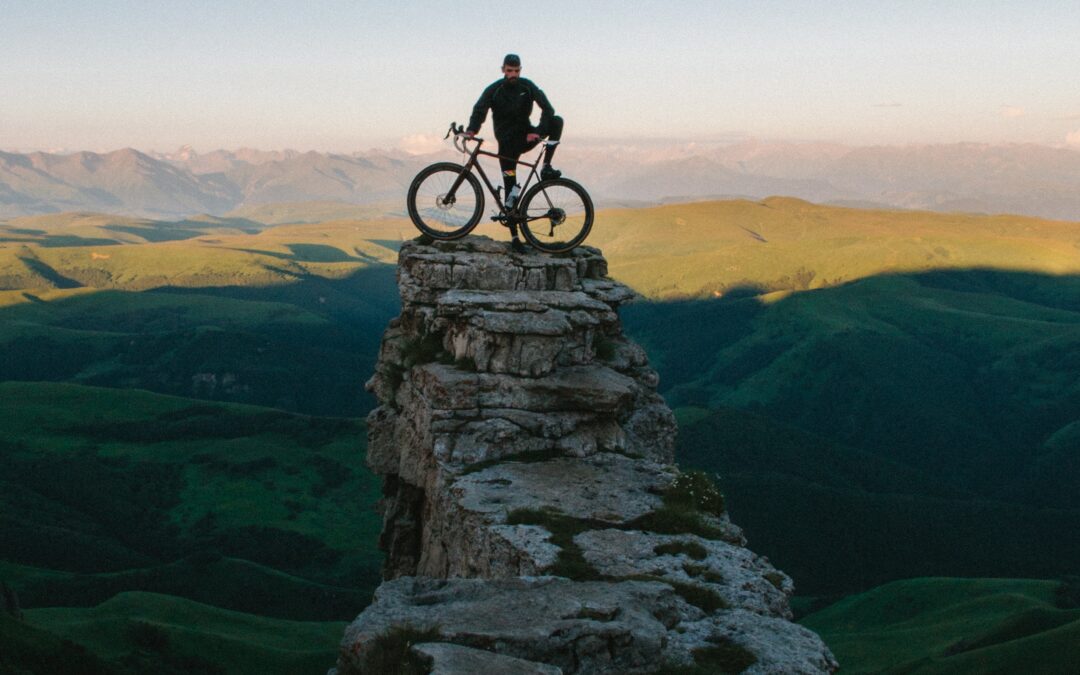 A cyclist and bike atop a rock path