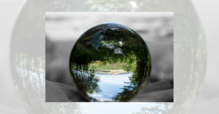 country scene reflected upside down in a glass sphere