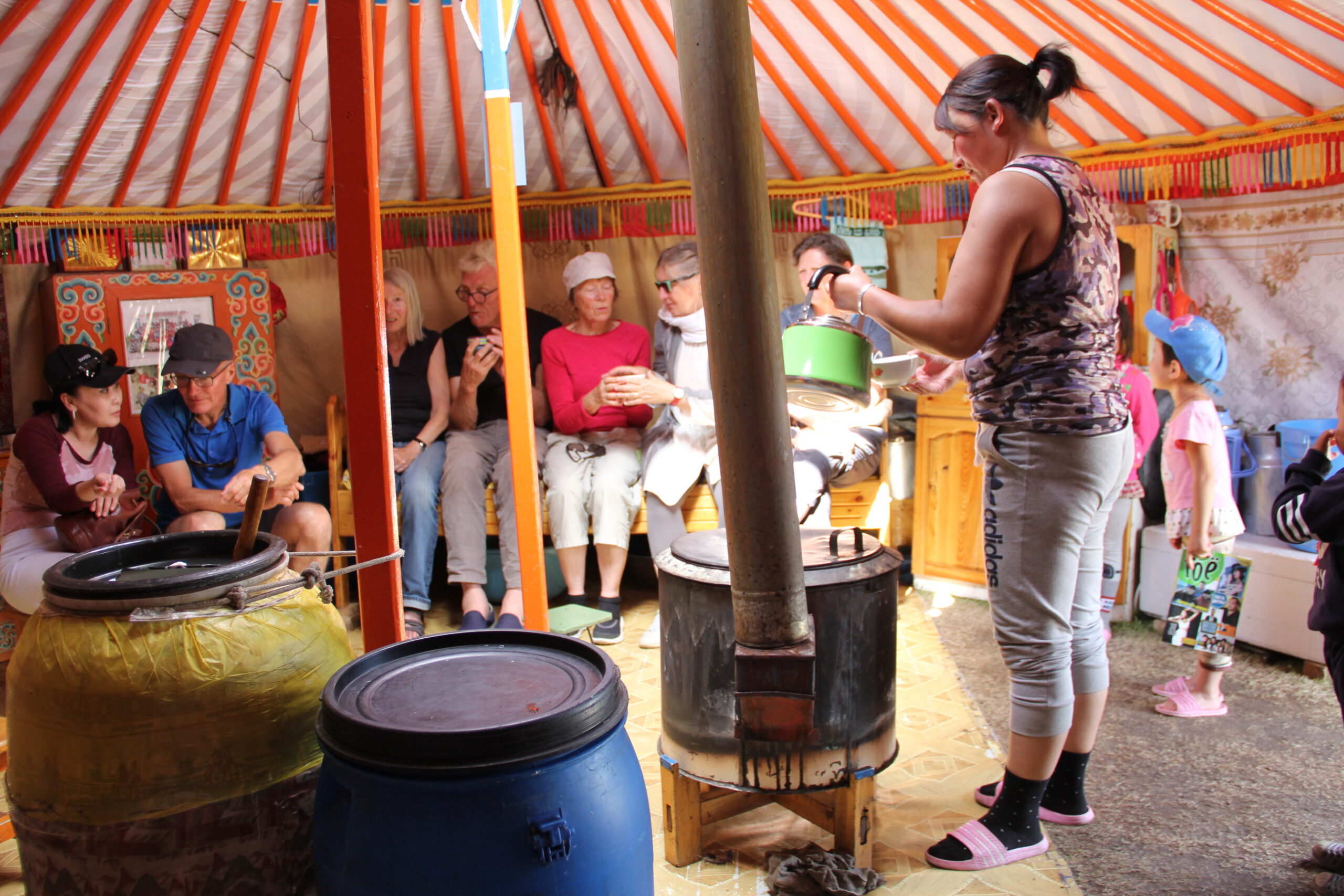 People drinking tea in a yurt.